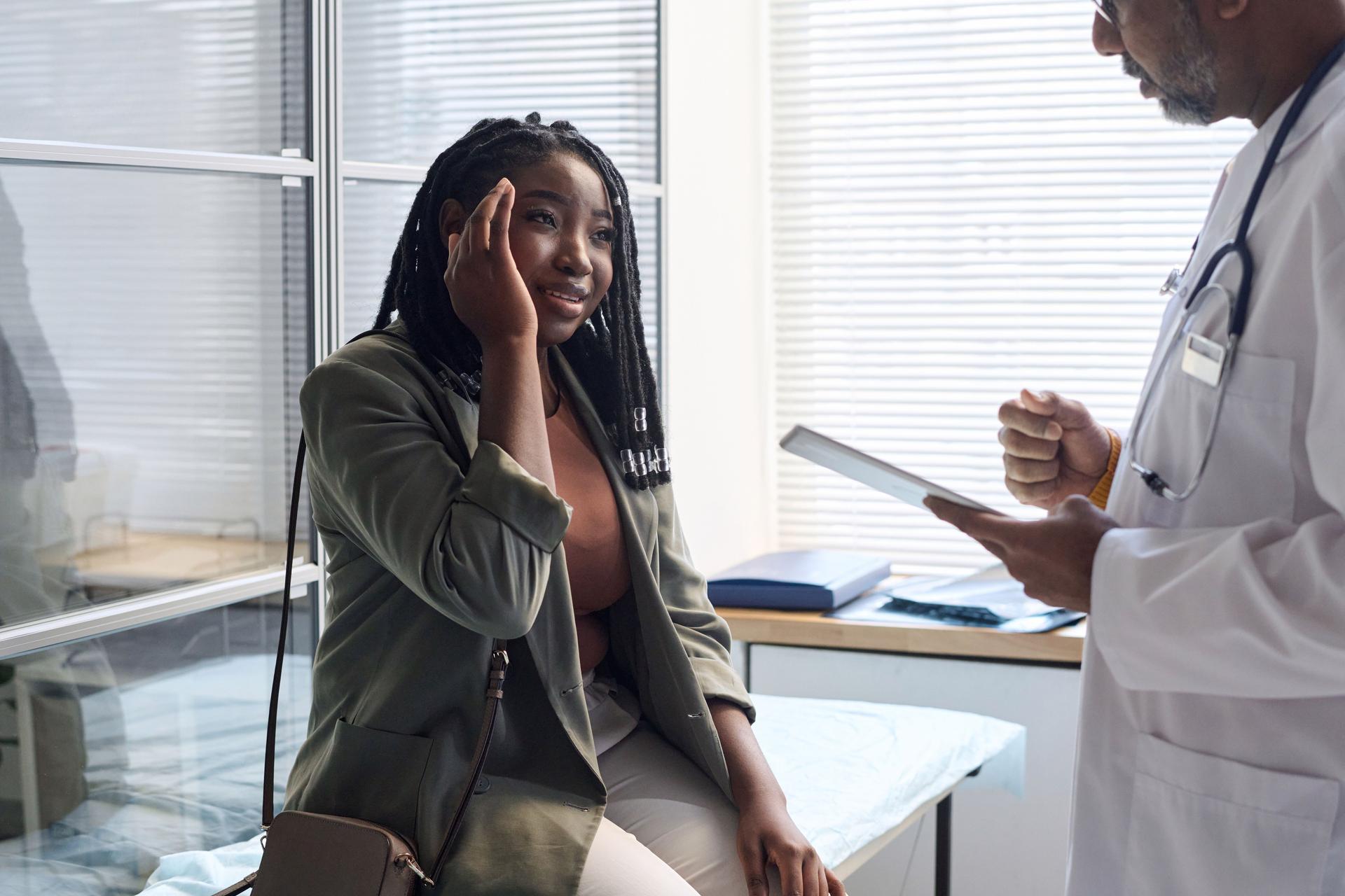Black Woman Suffering From Headache in Clinic